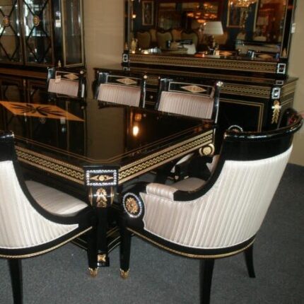 Glossy Black Dining Table with Gold Detailing and Striped Upholstered Chairs in Classical Interior
